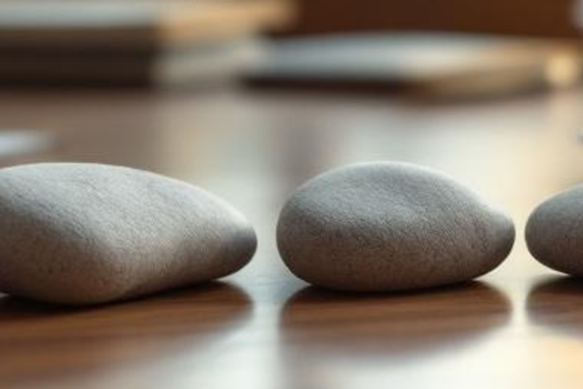 Close-up of smooth stones on a warm wooden surface representing ranked estate planning lead channels