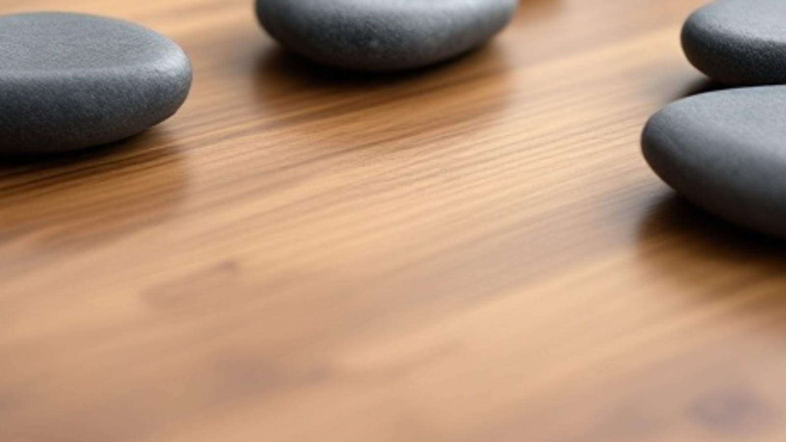 Smooth unmarked stones on a warm wooden tabletop arranged like nearby city paths for a local law firm website.