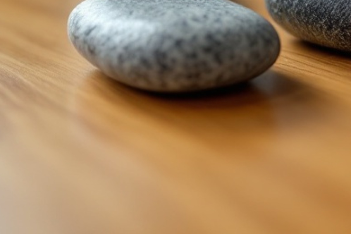 Close view of smooth unmarked stones on a wooden tabletop suggesting grouped city landing page paths.