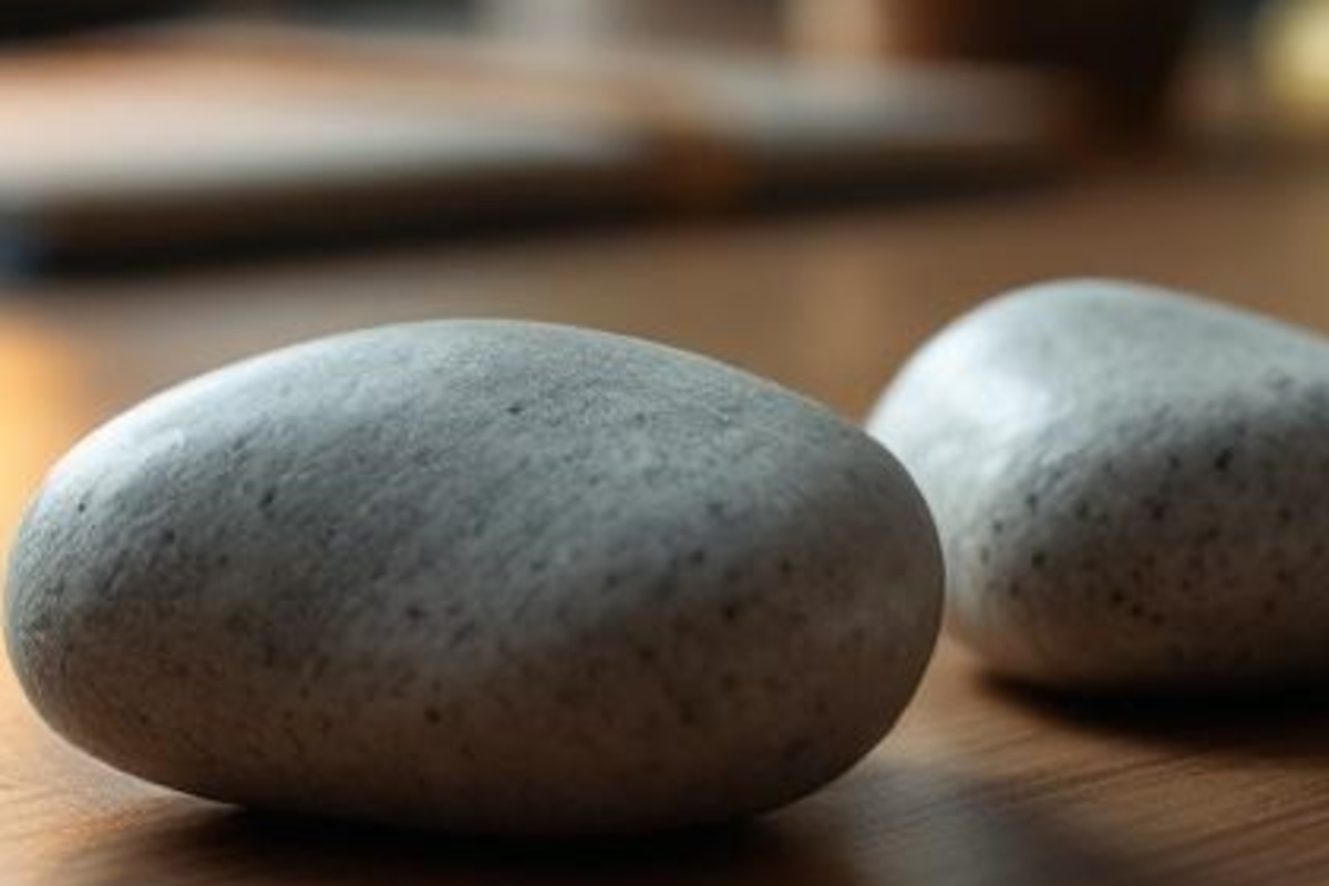 Close-up of smooth stones on a wooden tabletop representing a simple professional referral path